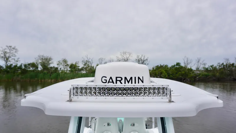 Slide: The Image of 2022 Costa Custom Boats 264 HC with Garmin equipment on a calm river. - 11