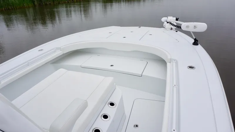 Slide: The Image of 2022 Costa Custom Boats 264 HC, sleek white deck, calm water backdrop. - 12