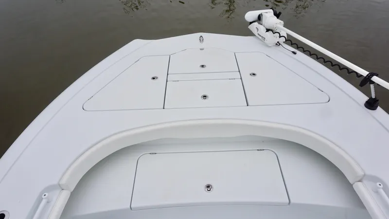 Slide: The Image of 2022 Costa Custom Boats 264 HC deck with storage compartments and trolling motor. - 14