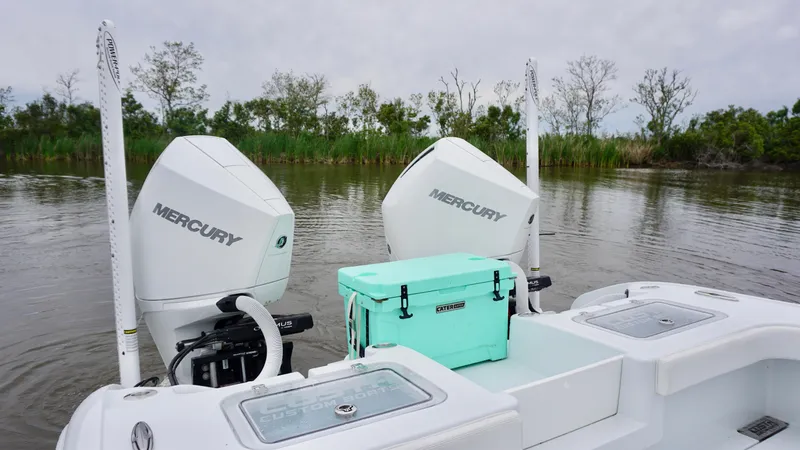 Slide: The Image of 2022 Costa Custom Boats 264 HC with twin Mercury engines on a calm river. - 16