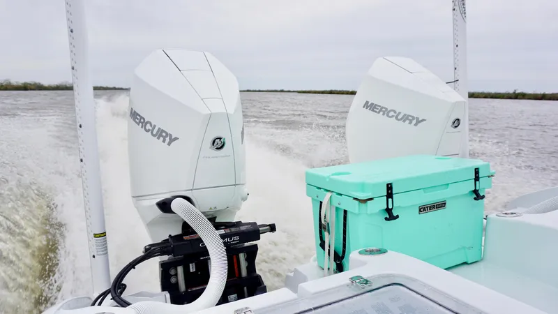 Slide: The Image of 2022 Costa Custom Boats 264 HC with dual Mercury engines and turquoise cooler on deck. - 17