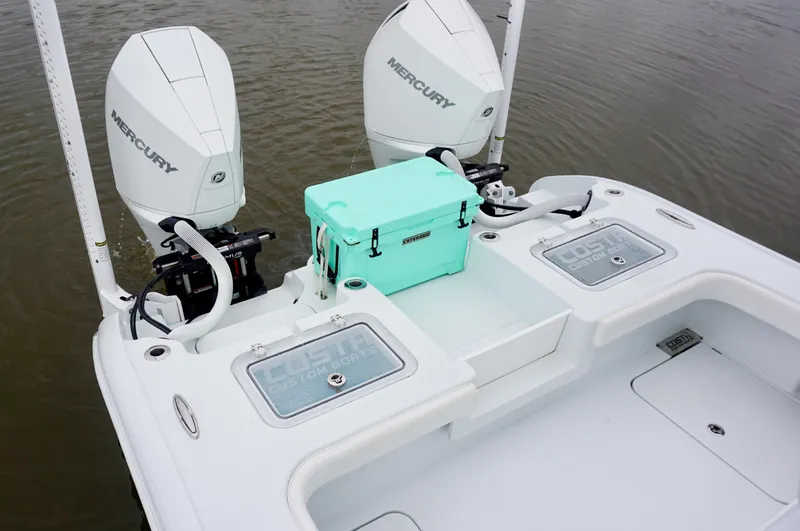 Slide: The Image of 2022 Costa Custom Boats 264 HC with twin Mercury engines and a turquoise cooler on deck. - 18