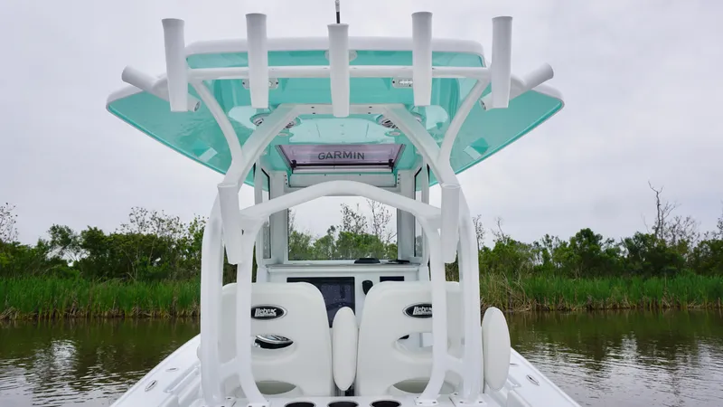 Slide: The Image of 2022 Costa Custom Boats 264 HC with rod holders and Garmin equipment, on a calm waterway. - 21
