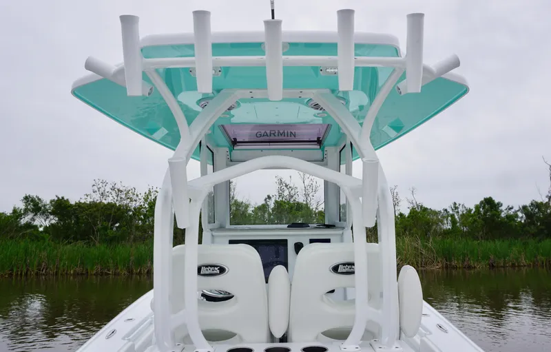 Slide: The Image of 2022 Costa Custom Boats 264 HC, rear view, featuring rod holders and helm station. - 22