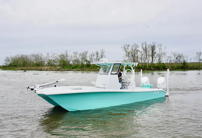 Slide: The Image of 2022 Costa Custom Boats 264 HC on calm water, featuring a sleek design and mint green hull. - 3