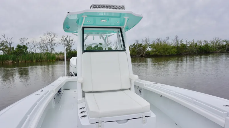 Slide: The Image of 2022 Costa Custom Boats 264 HC on calm water, featuring sleek white seating and modern design. - 7