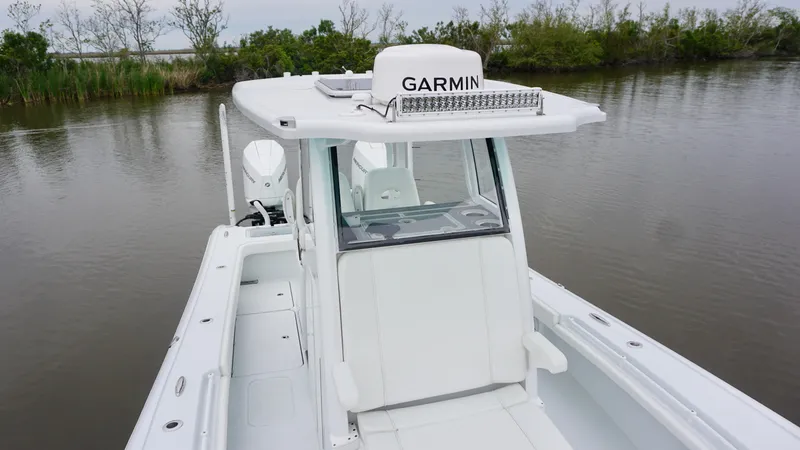 Slide: The Image of 2022 Costa Custom Boats 264 HC on calm water, featuring Garmin equipment. - 8