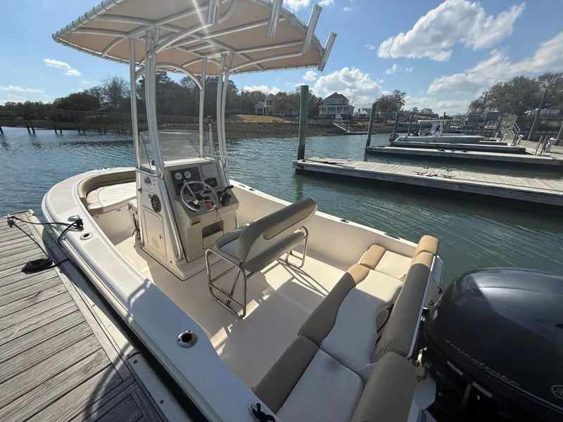 Slide: The Image of 2015 Pioneer 180 Islander boat docked at marina under clear sky. - 10