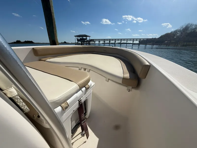 Slide: The Image of 2015 Pioneer 180 Islander boat interior with seating, dock, and water view. - 12