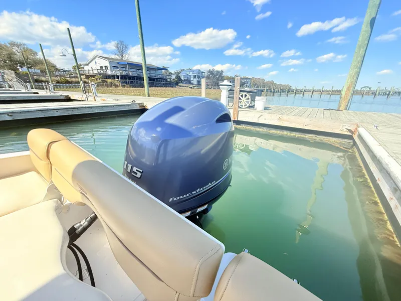Slide: The Image of 2015 Pioneer 180 Islander boat docked with Yamaha 115 outboard motor. - 15