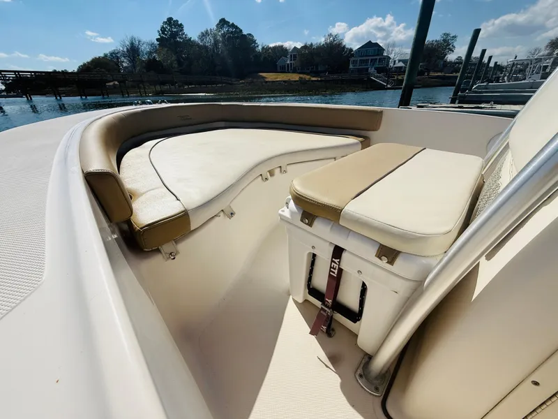 Slide: The Image of 2015 Pioneer 180 Islander boat interior with cushioned seating and storage. - 5