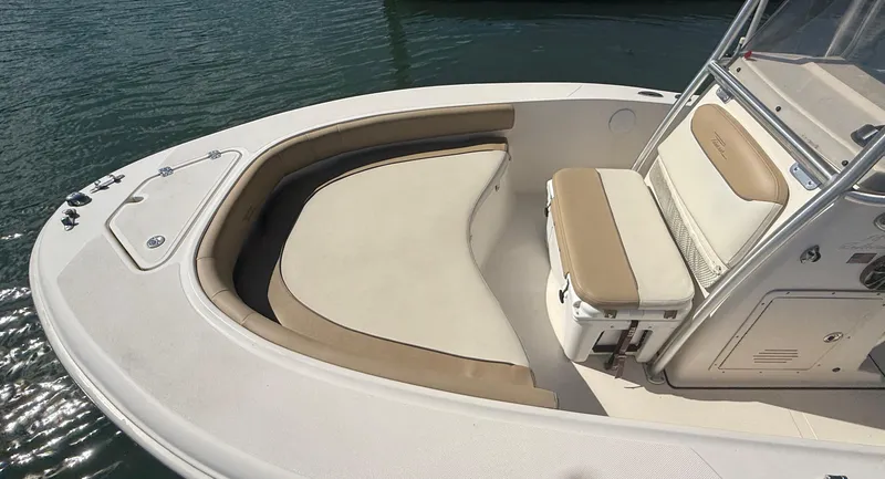 Slide: The Image of 2015 Pioneer 180 Islander boat interior with cushioned seating and console. - 7