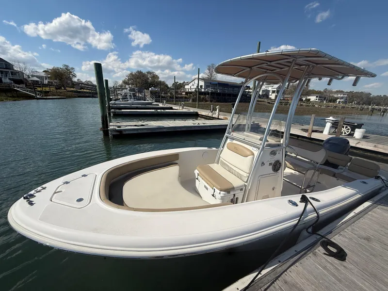 Slide: The Image of 2015 Pioneer 180 Islander boat docked at marina under clear sky. - 8