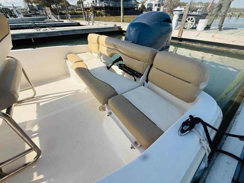 Slide: The Image of 2015 Pioneer 180 Islander boat interior with beige seating and outboard motor. - 9