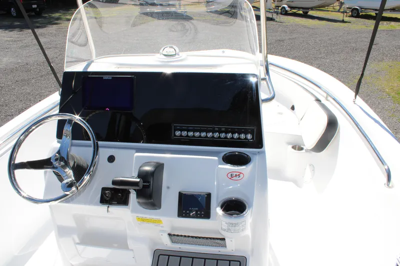 Slide: The Image of 2025 Tidewater 198 CC Adventure boat console with steering wheel and navigation controls. - 14