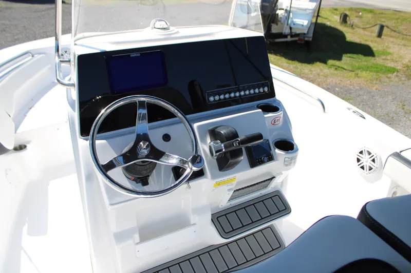 Slide: The Image of 2025 Tidewater 198 CC Adventure boat console with steering wheel and controls. - 17