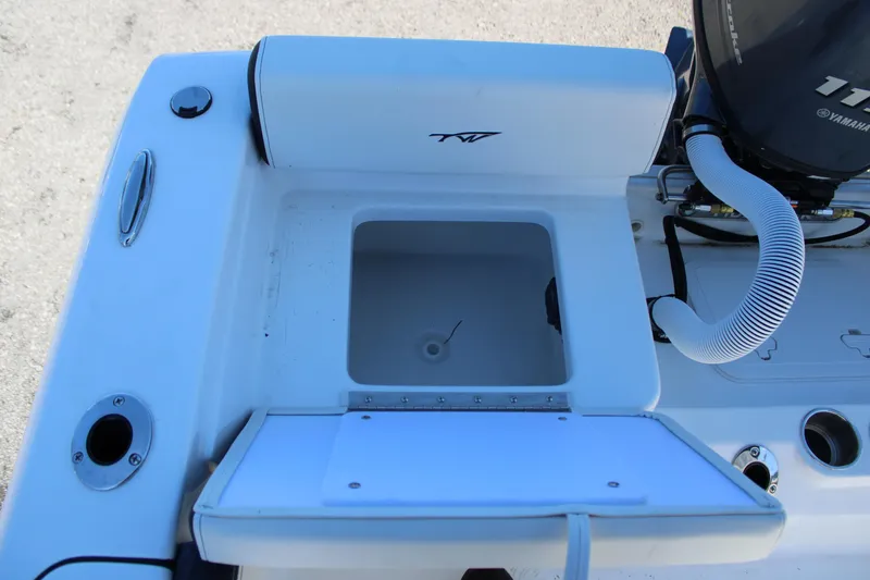 Slide: The Image of 2025 Tidewater 198 CC Adventure boat with open storage compartment and engine detail. - 19