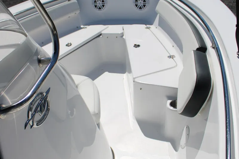 Slide: The Image of 2025 Tidewater 198 CC Adventure boat interior with white seating and storage compartments. - 25