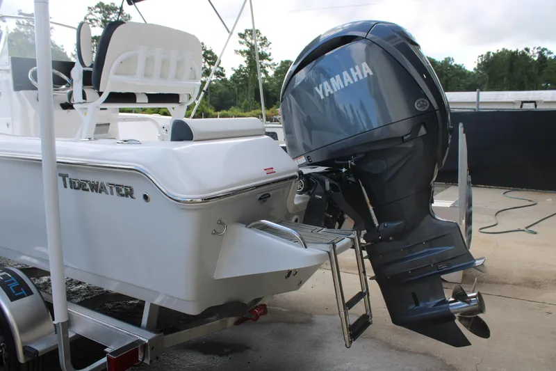 Slide: The Image of 2025 Tidewater 198 CC Adventure boat with Yamaha outboard motor, docked on a trailer. - 26