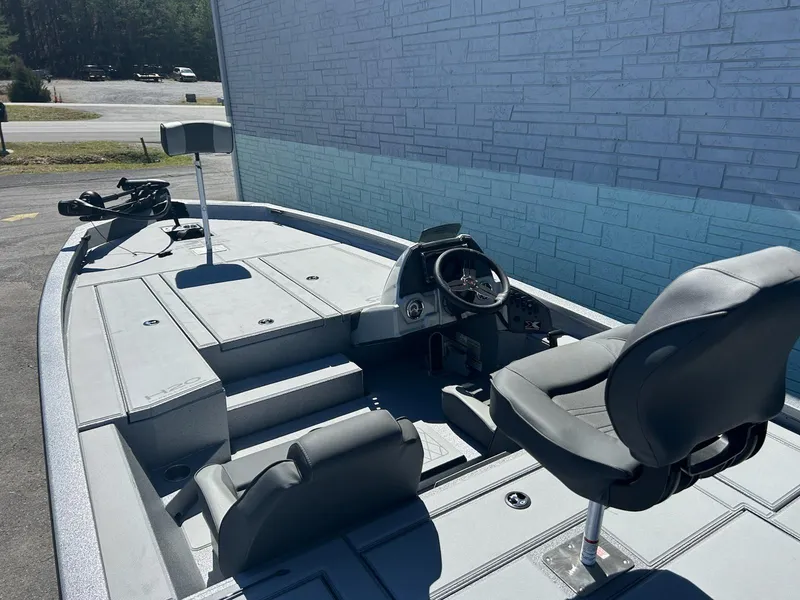 Slide: The Image of 2025 Express H20 Bass boat interior with seating and steering console. - 10