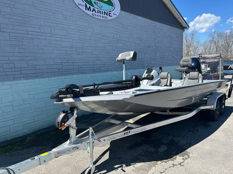 Slide: The Image of 2025 Express H20 Bass boat on trailer, parked outside a marine shop. - 2