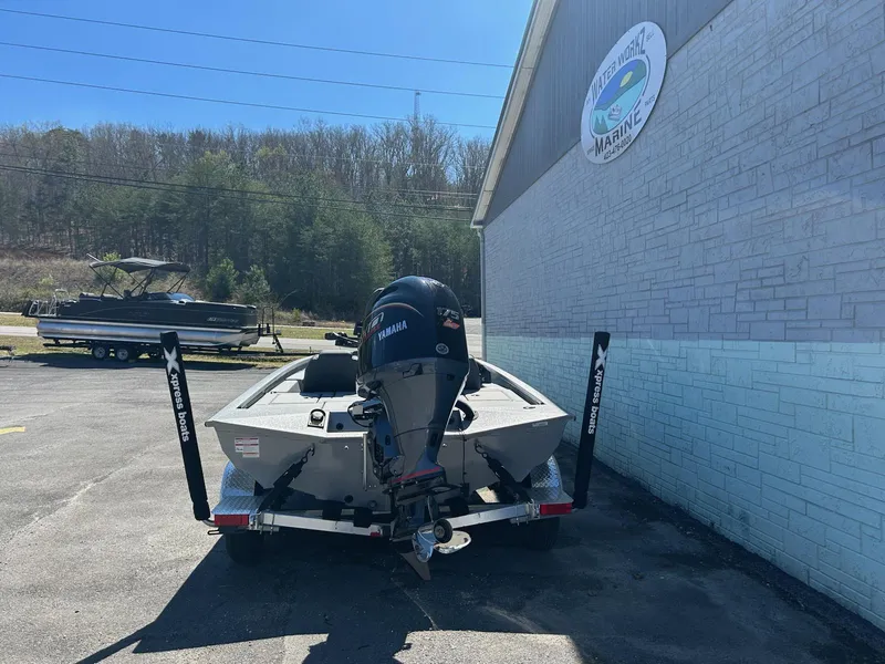 Slide: The Image of 2025 Express H20 Bass boat with Yamaha motor parked outside a marine shop. - 3