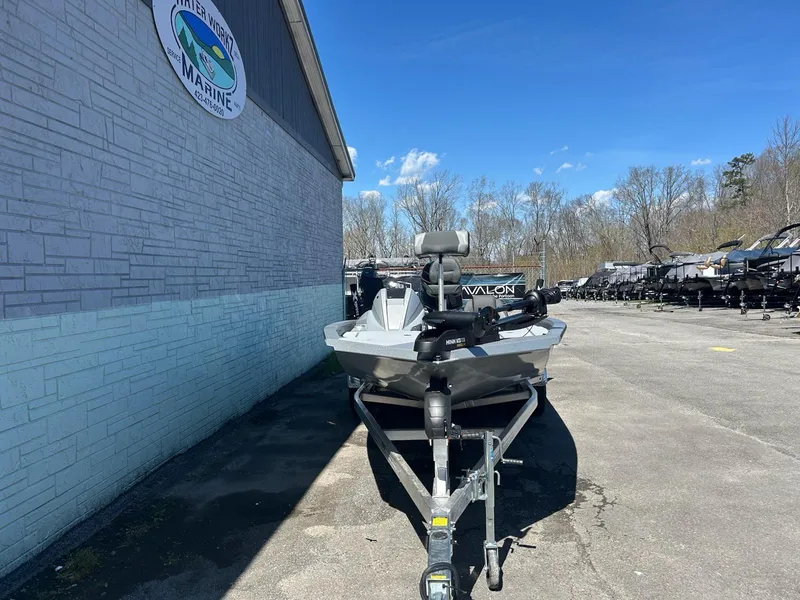 Slide: The Image of 2025 Express H20 Bass boat on trailer, parked outside a marine dealership. - 5