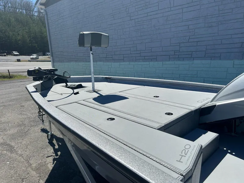 Slide: The Image of 2025 Express H20 Bass boat with sleek design, parked outdoors. - 6