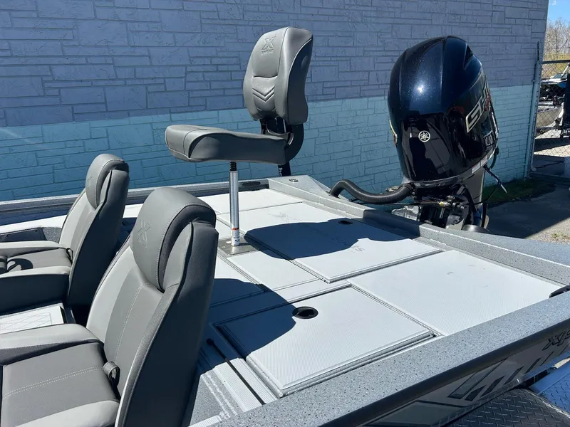 Slide: The Image of 2025 Express H20 Bass boat with gray seating and powerful outboard motor. - 8