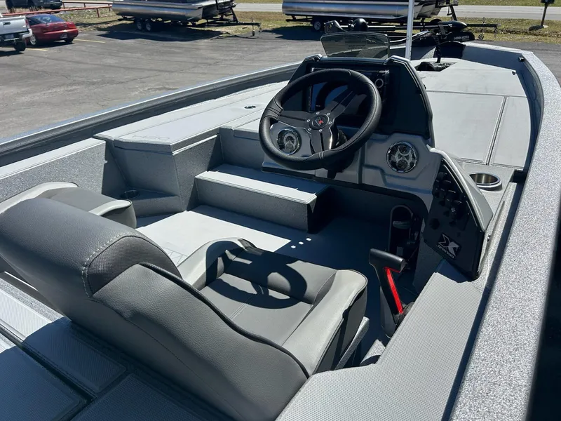 Slide: The Image of 2025 Express H20 Bass boat interior with steering wheel and seating. - 9