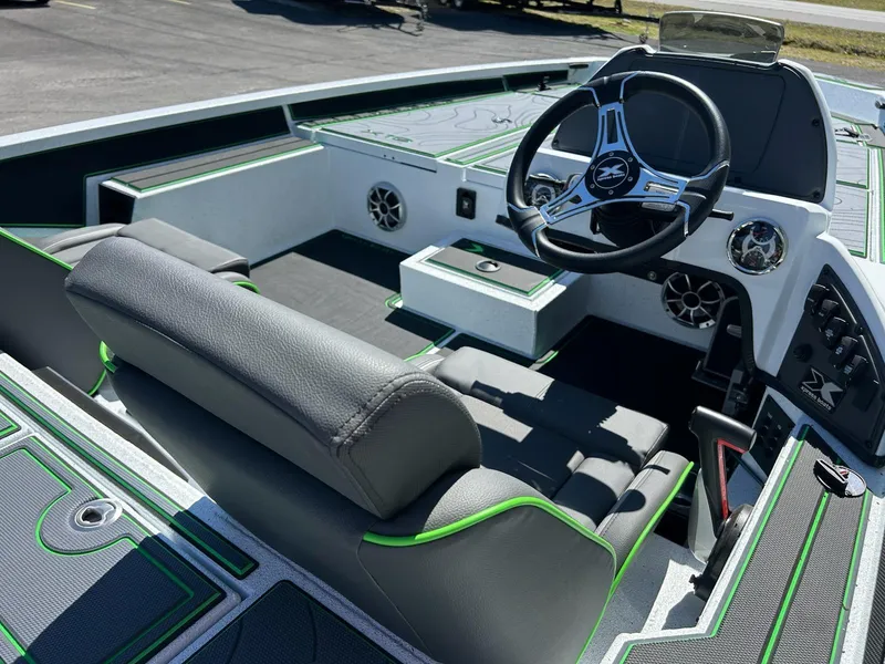 Slide: The Image of 2025 Xpress X19 Pro boat interior with modern steering wheel and seating. - 8