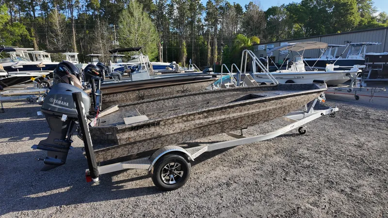 Slide: The Image of 2025 Xpress H18DB boat with Yamaha motor on trailer, parked outdoors. - 12