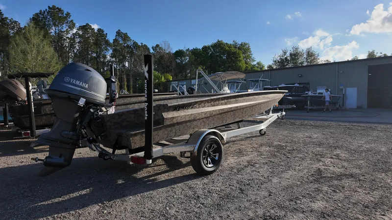 Slide: The Image of 2025 Xpress H18DB boat on trailer with Yamaha engine, parked outdoors. - 15