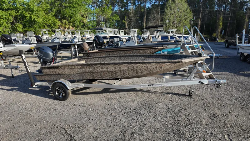 Slide: The Image of 2025 Xpress H18DB boat on trailer in outdoor showroom. - 16