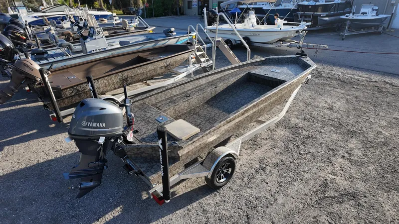 Slide: The Image of 2025 Xpress H18DB boat with Yamaha motor on trailer, parked outdoors. - 18