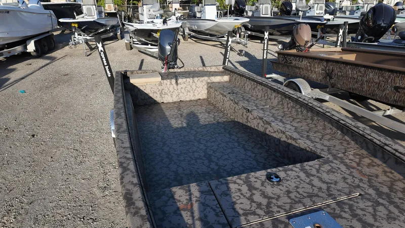 Slide: The Image of 2025 Xpress H18DB boat with camouflage design in a boatyard. - 23