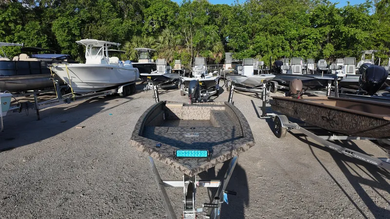 Slide: The Image of 2025 Xpress H18DB boat on trailer in outdoor lot with various other boats. - 27