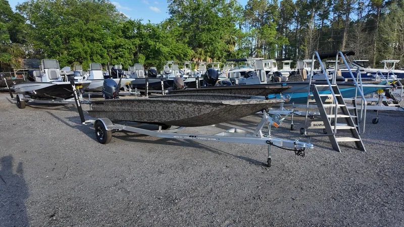 Slide: The Image of 2025 Xpress H18DB boat on trailer in outdoor showroom. - 3