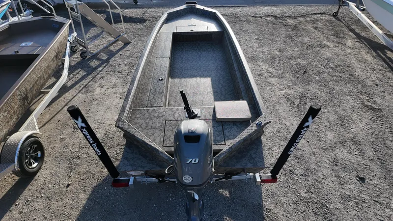 Slide: The Image of 2025 Xpress H18DB boat with motor, parked on gravel, viewed from above. - 32