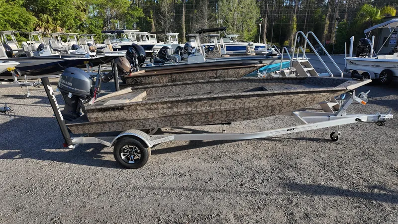 Slide: The Image of 2025 Xpress H18DB boat on trailer in outdoor showroom. - 5