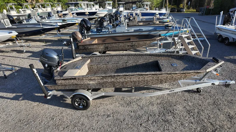 Slide: The Image of 2025 Xpress H18DB boat on trailer in outdoor showroom. - 7