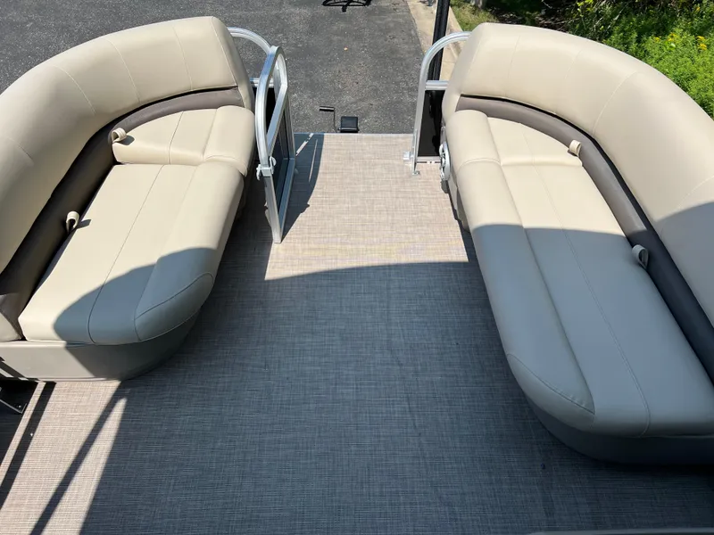 Slide: The Image of 2025 Sun Tracker Party Barge 16 DLX interior with beige seating and open deck. - 7