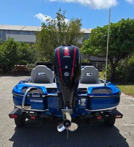 Slide: The Image of 2025 Nitro Z18 boat, rear view, blue color, parked outdoors. - 11