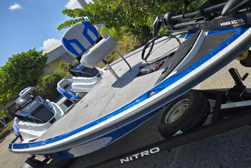 Slide: The Image of 2025 Nitro Z18 boat with blue accents on a trailer, featuring a Minn Kota trolling motor. - 3