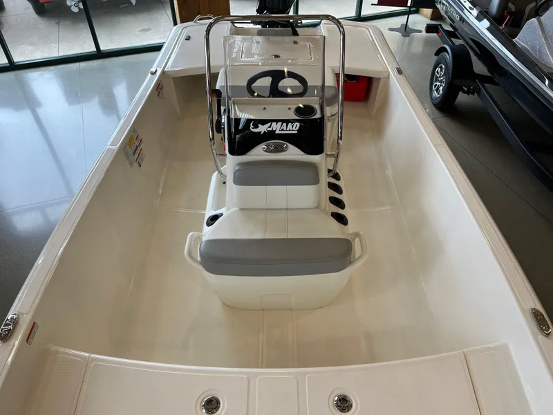 Slide: The Image of 2024 Mako Pro Skiff 17 CC boat interior with steering console and seating. - 3