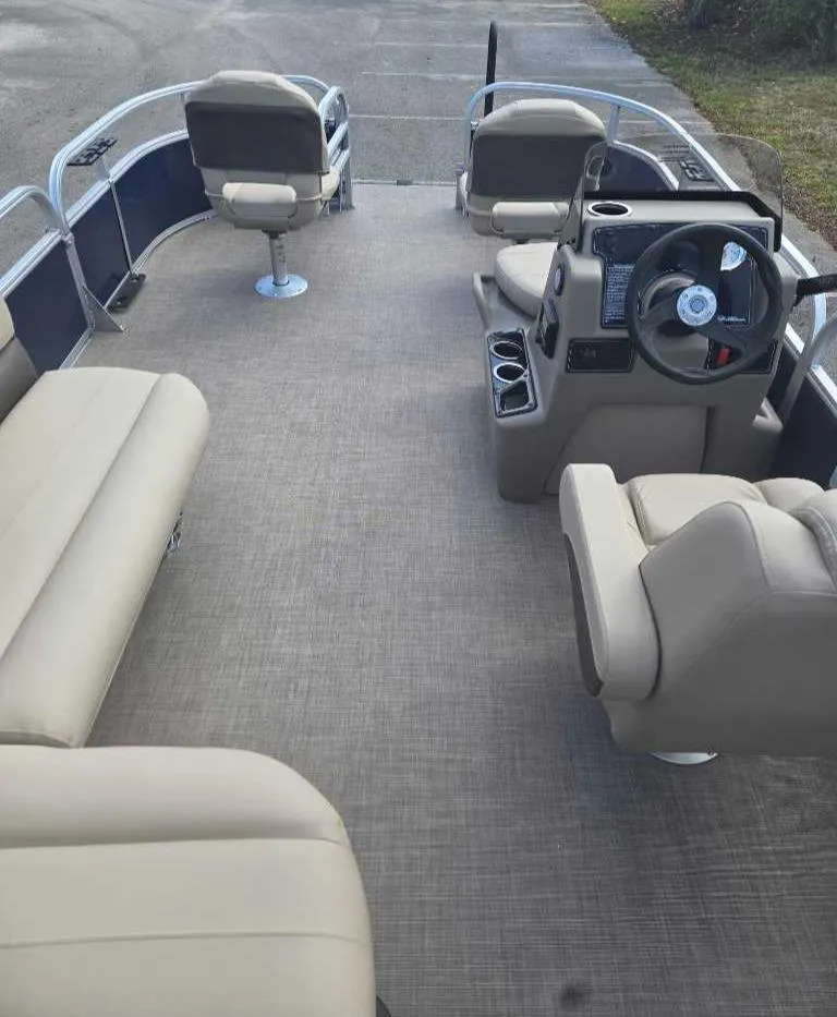 Slide: The Image of 2025 Sun Tracker Bass Buggy 16 XL Select pontoon boat interior with beige seating and steering console. - 10