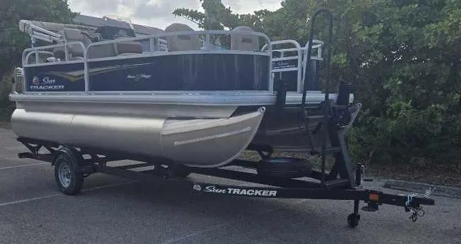 Slide: The Image of 2025 Sun Tracker Bass Buggy 16 XL Select pontoon boat on trailer. - 3