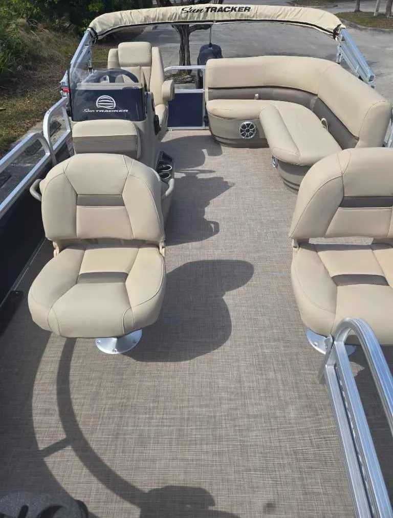 Slide: The Image of 2025 Sun Tracker Bass Buggy 16 XL Select pontoon boat with beige seating and spacious deck. - 6