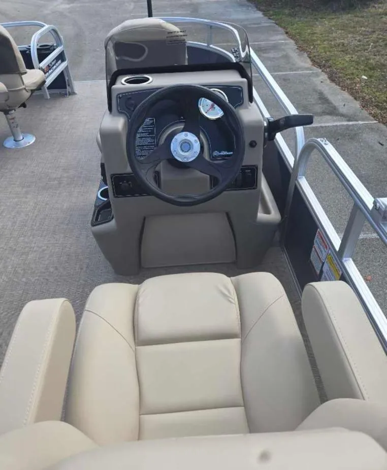 Slide: The Image of 2025 Sun Tracker Bass Buggy 16 XL Select interior with steering wheel and seating. - 9