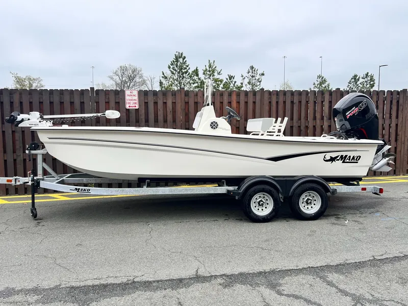 The Image of 2025 Mako Pro Skiff 19 CC boat on trailer, parked outdoors. - 0